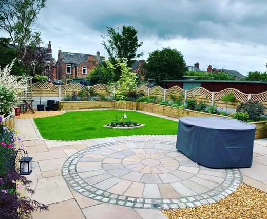 Garden transformation with a circular sandstone patio ringed in setts, new lawn, sleeper borders and gravel